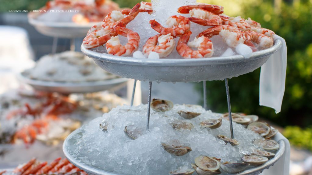 Seafood tower with shrimp and oysters on ice