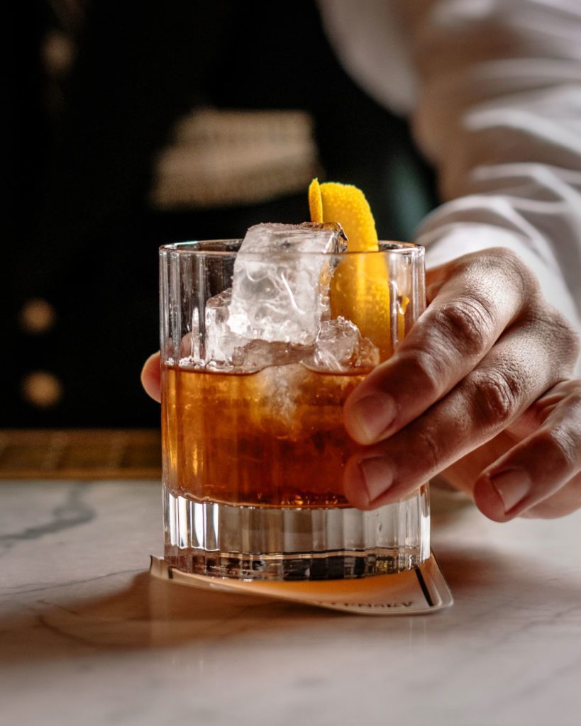 Bartender is holding old-fashioned cocktail