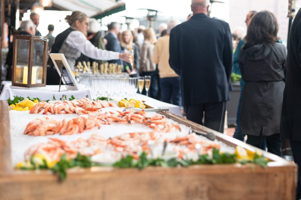 An event serving shrimp and glasses of champagne