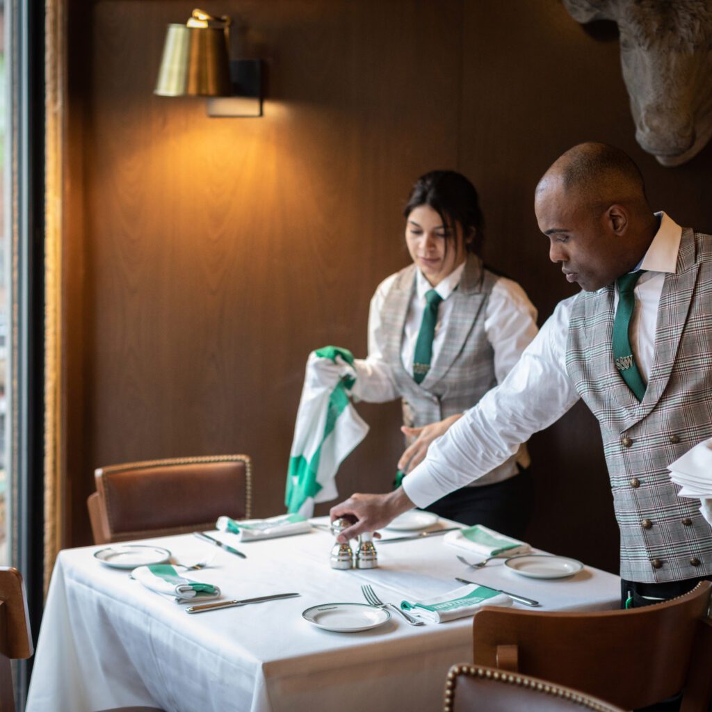 S&W waiters are dressing a table