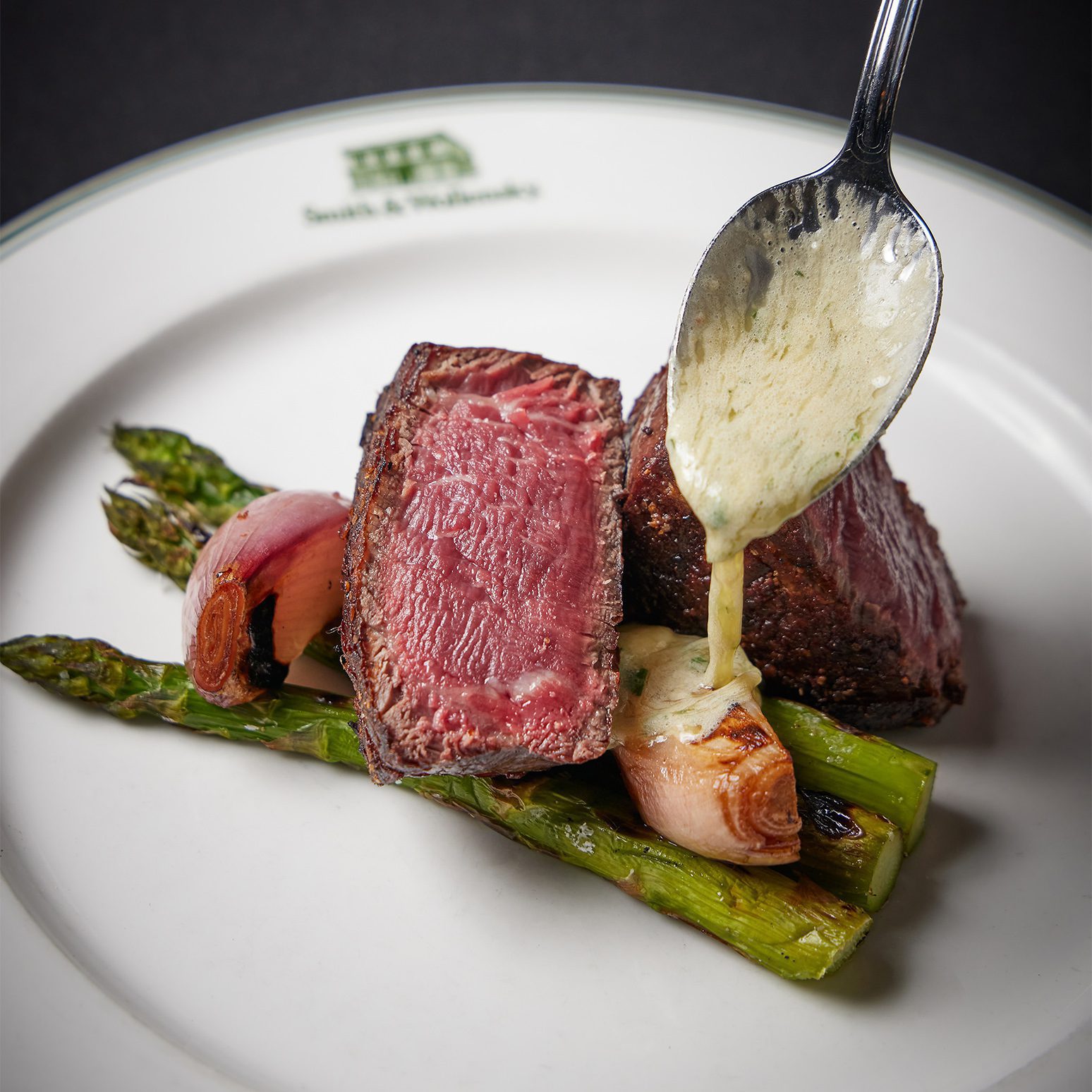 Steak dish with asparagus and onion