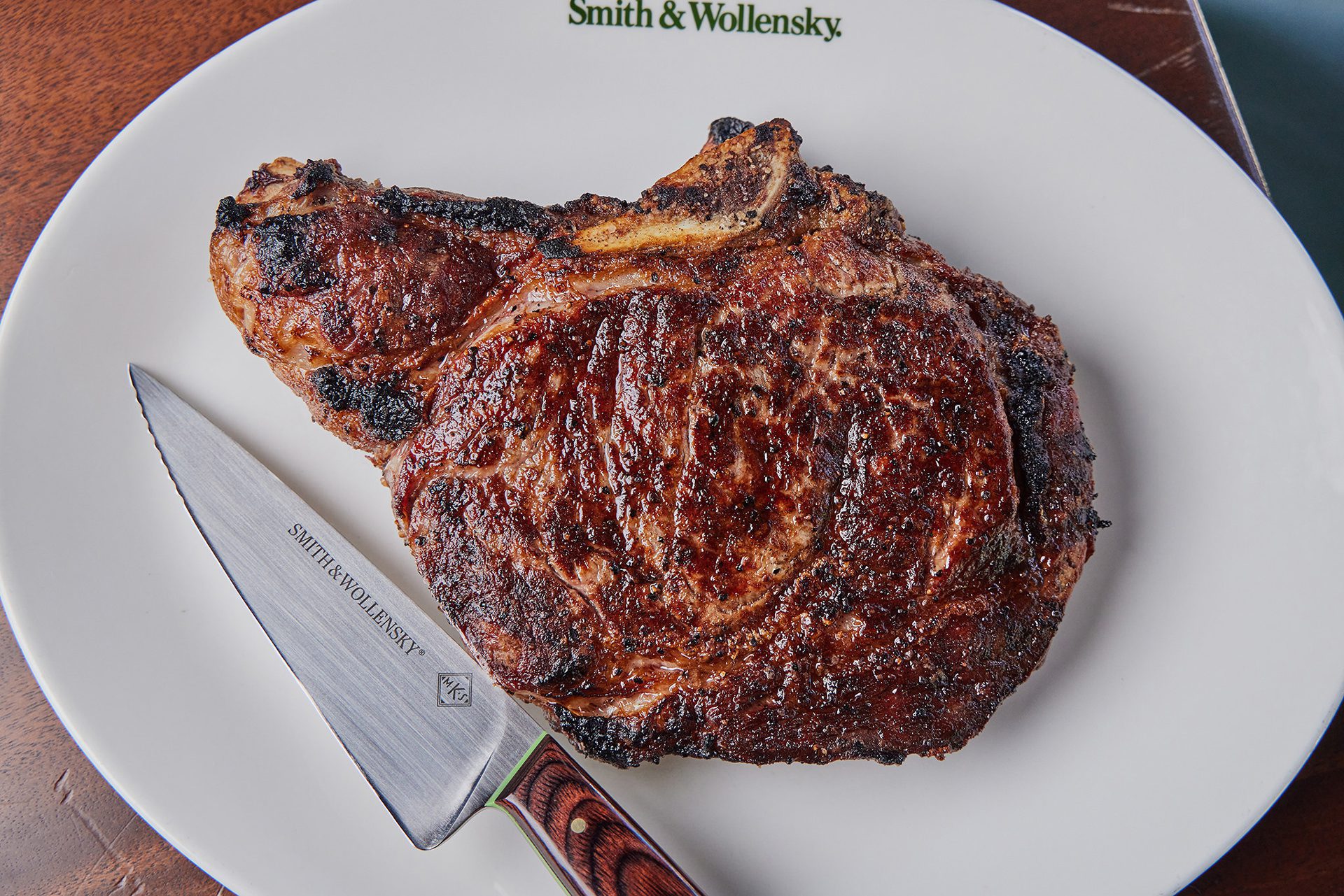 S&W steak on a white plate with a knife