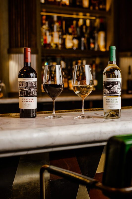 Red and white wines on the top of a white counter