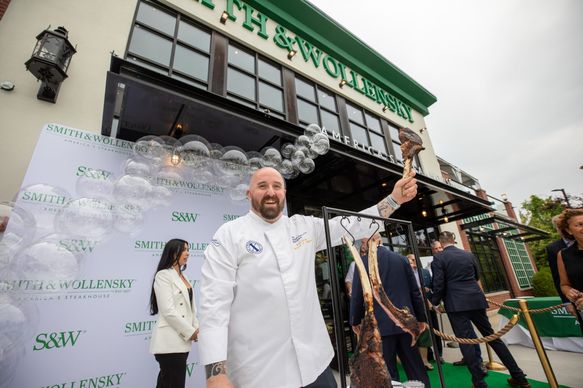 Chef holding tomahawk steak outside Burlington Smith & Wollensky