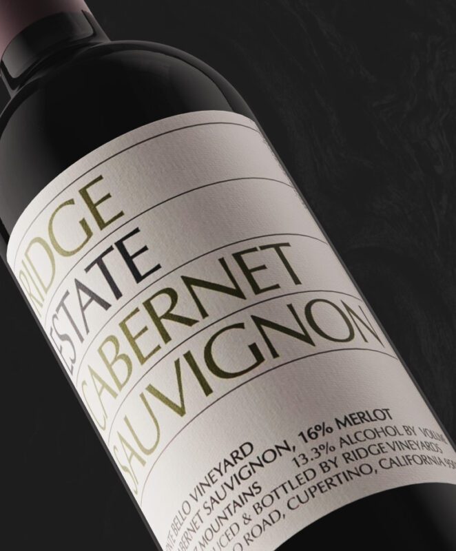 A close-up of a wine bottle labeled “Ridge Estate Cabernet Sauvignon.” The label also notes 16% Merlot, 13.3% alcohol, and that it is produced and bottled in Cupertino, California.
